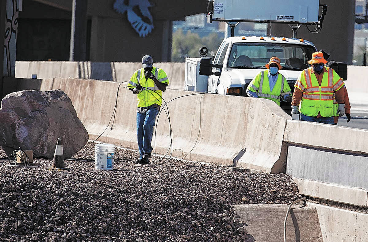 Nevada Department of Transportation workers replace copper wire after Spaghetti Bowl lights wer ...