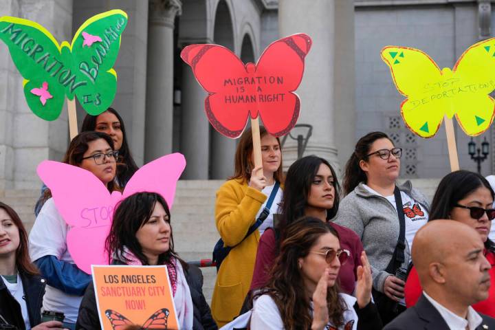 Members of immigration advocacy groups demand the City Council enact an ordinance making Los An ...