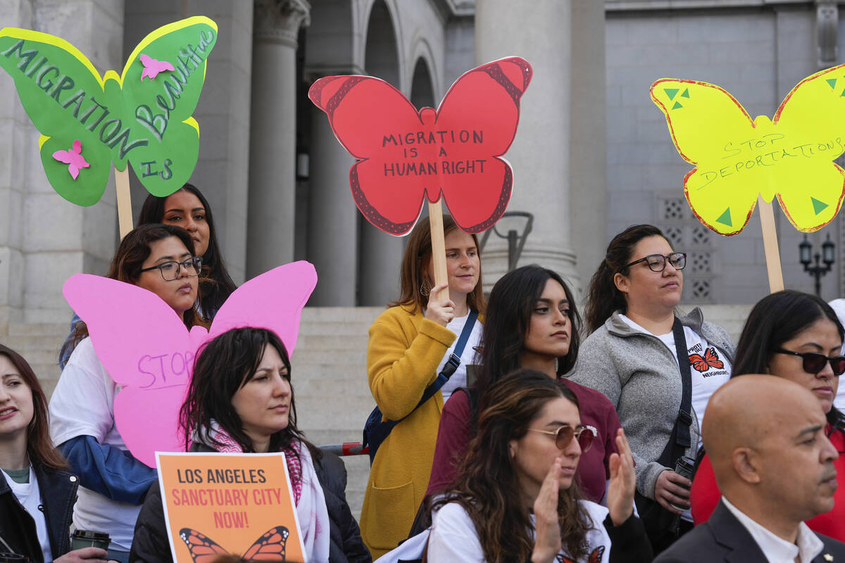 Members of immigration advocacy groups demand the City Council enact an ordinance making Los An ...