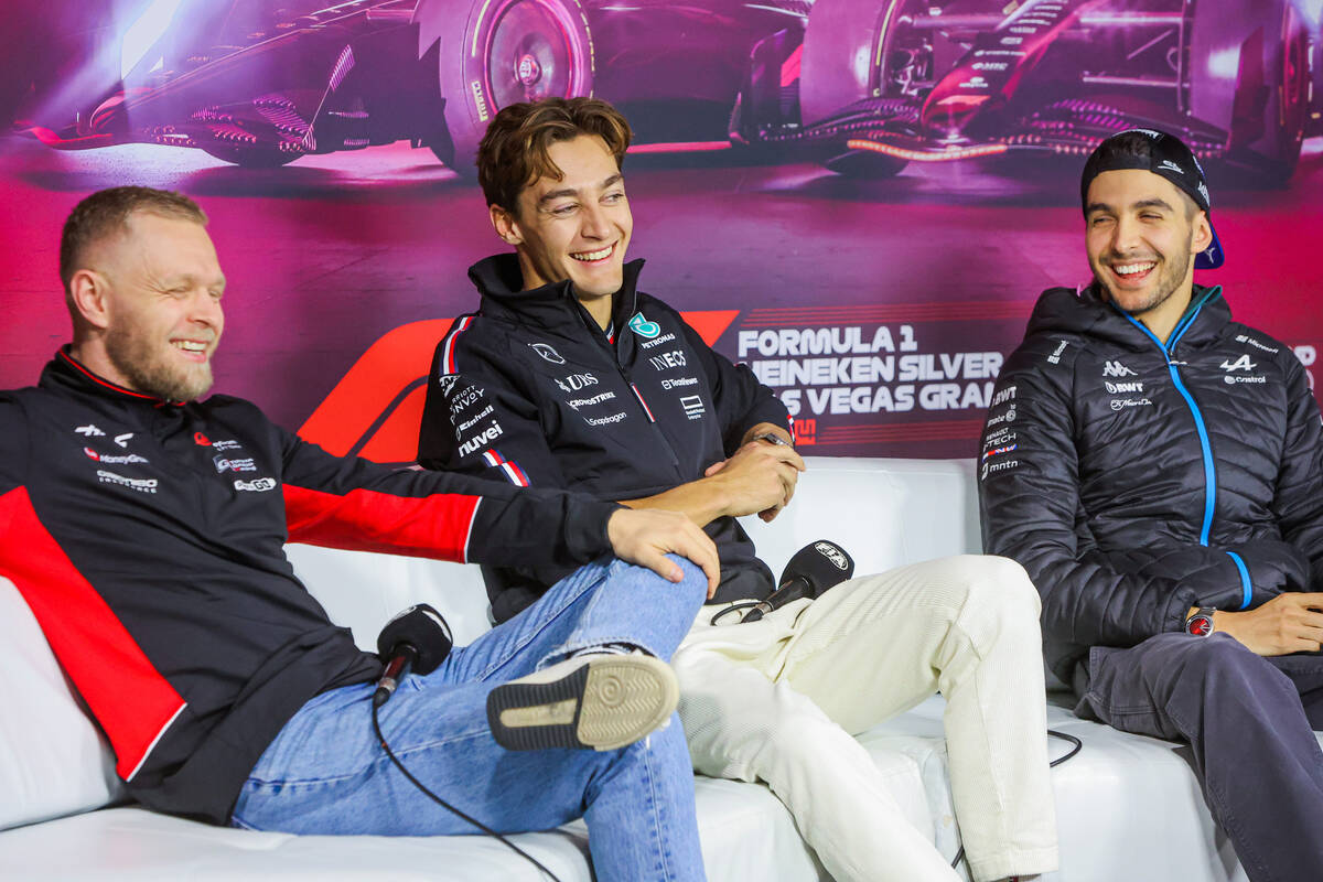 Formula 1 drivers Kevin Magnussen, from left, George Russell, and Esteban Ocon share a laugh du ...