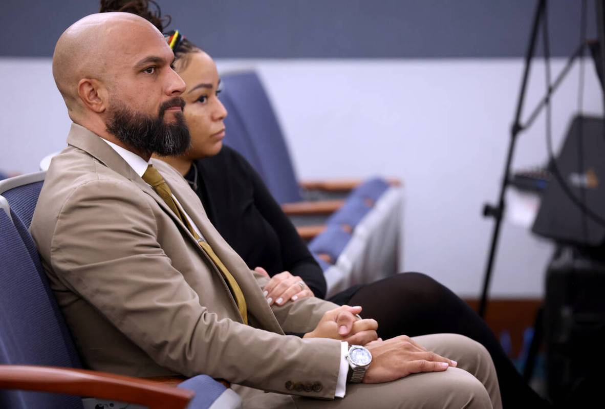 Metropolitan Police Department Sgt. Kevin Menon waits in court with his wife, Natasha, at the R ...