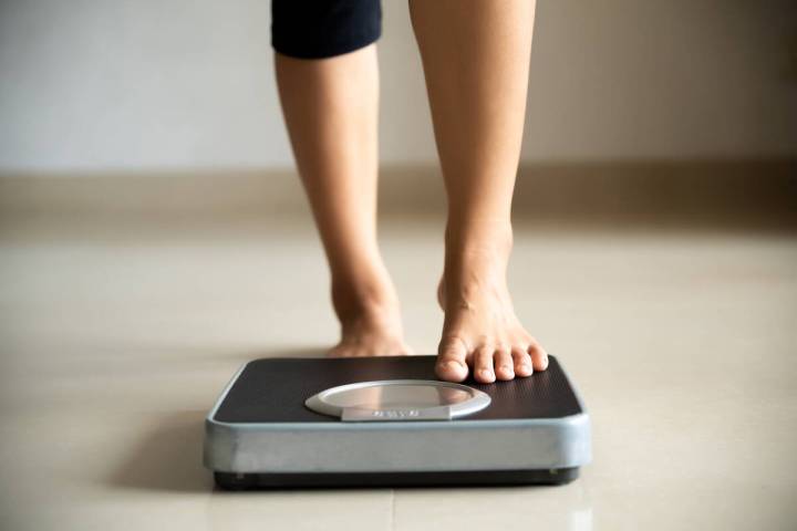 Controlling your weight lowers your triglycerides and improves your HDL levels. (Getty Images)