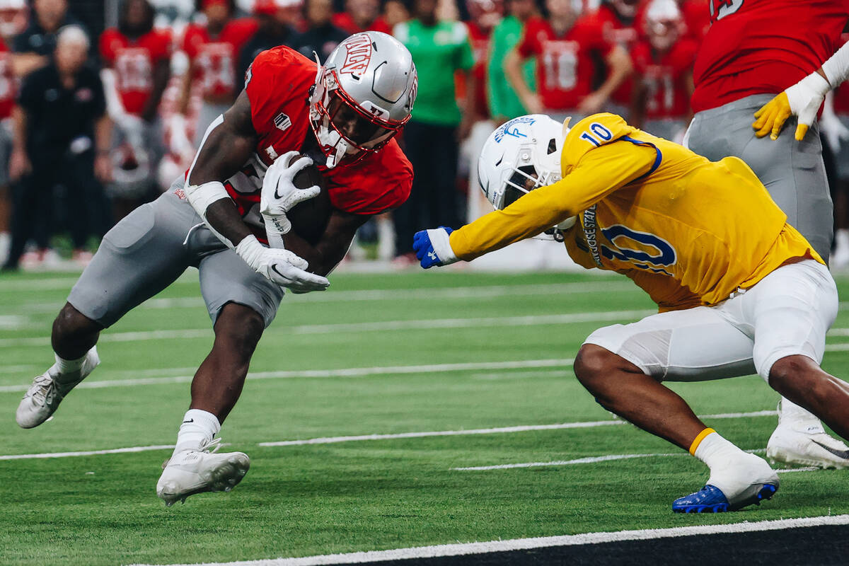 UNLV running back Jai'Den Thomas (22) makes it into the end zone for a touchdown during a footb ...