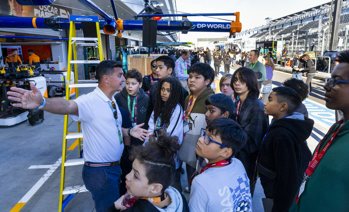 McLaren test driver Andre D'Cruze interacts with Kenny C. Guinn Middle School students as a mem ...