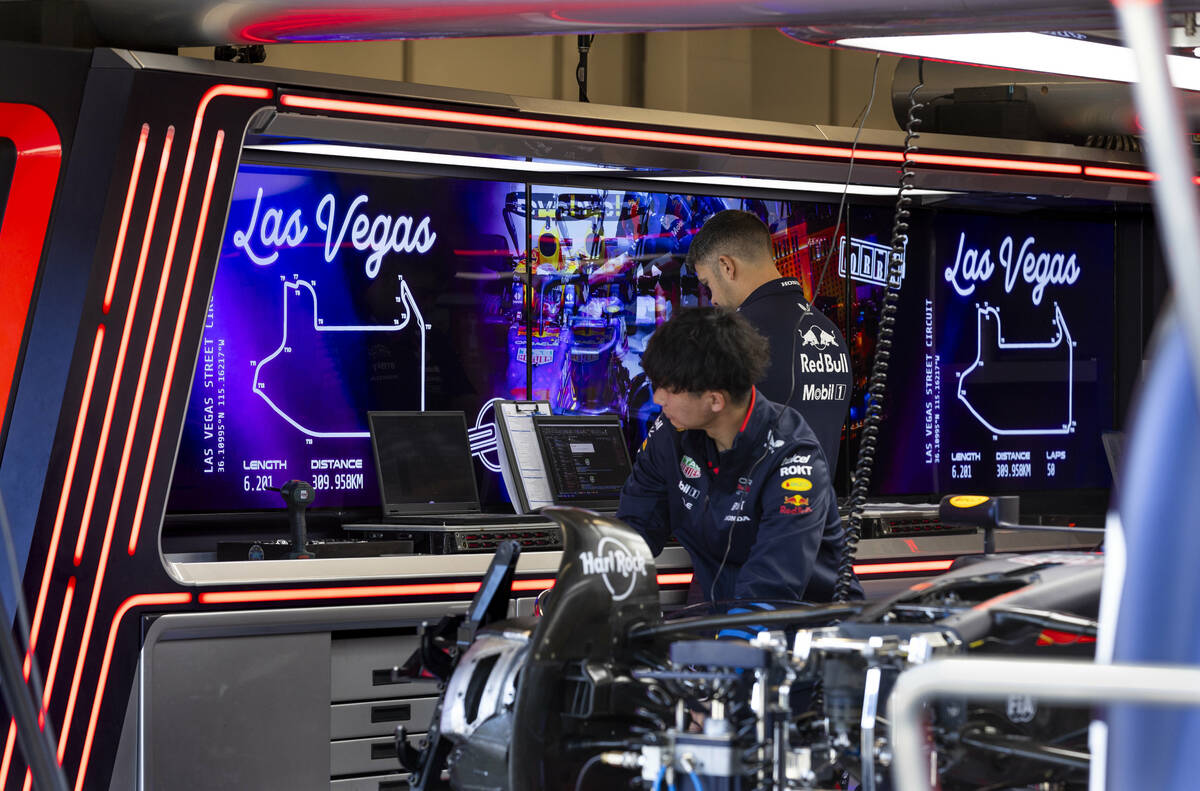 Technicians work on the car of Red Bull driver Max Verstappen in his garage at the Formula 1 ...