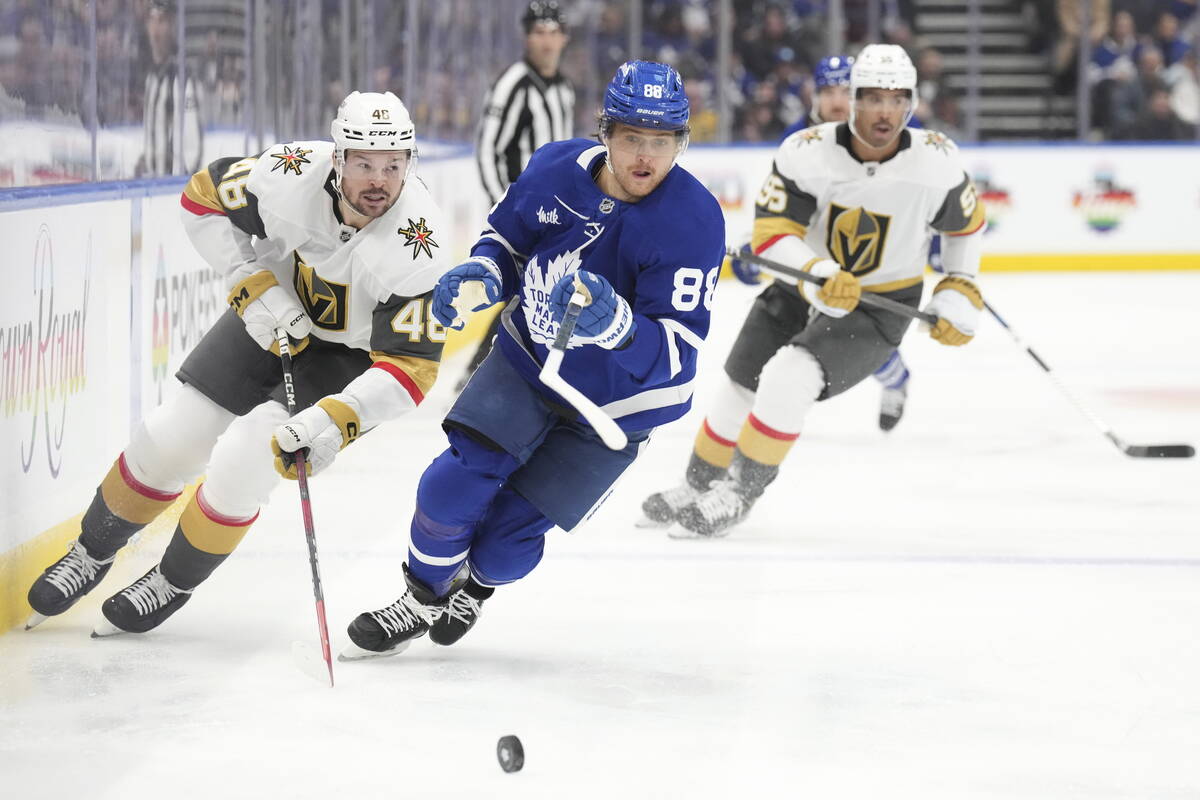 Toronto Maple Leafs' William Nylander (88) and Vegas Golden Knights' Tomas Hertl (48) chase dow ...