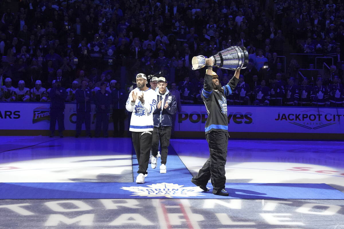 Toronto Argonauts' Wynton McManis displays the Grey Cup as he is joined by team mates at centre ...