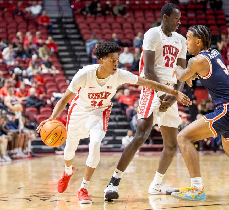 UNLV guard DeMarion Yap (24) runs around forward Pape N'Diaye (22) during the college basketbal ...