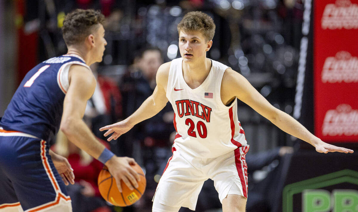 UNLV guard Julian Rishwain (20) guards Pepperdine Waves guard David Mager (1) during the colleg ...