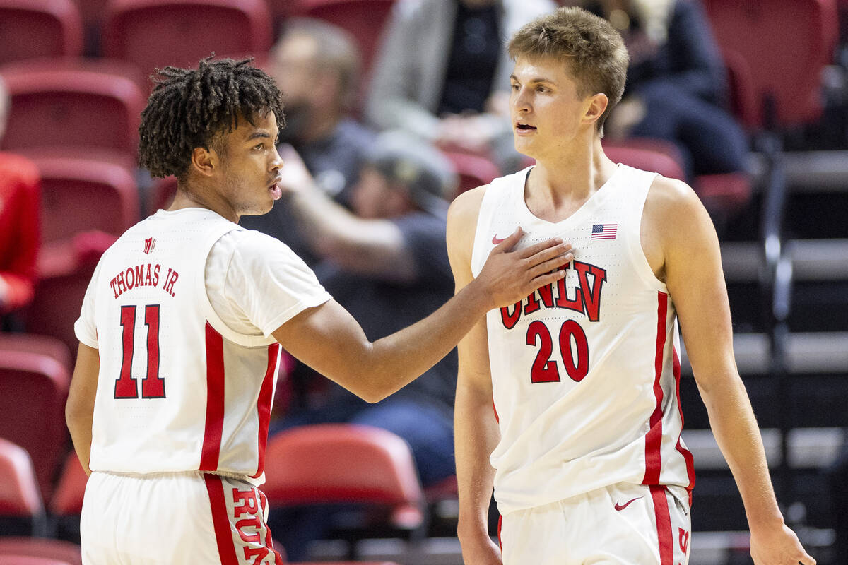 UNLV guard Dedan Thomas Jr. (11) and guard Julian Rishwain (20) celebrate a play during the col ...