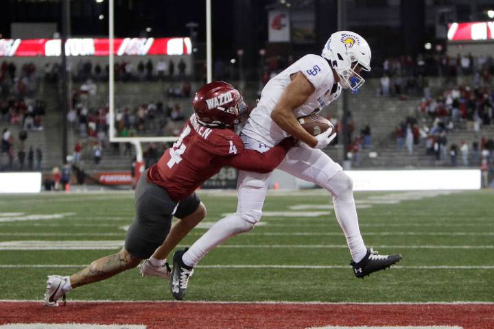 San Jose State wide receiver Nick Nash, right, scores a touchdown while pressured by Washington ...