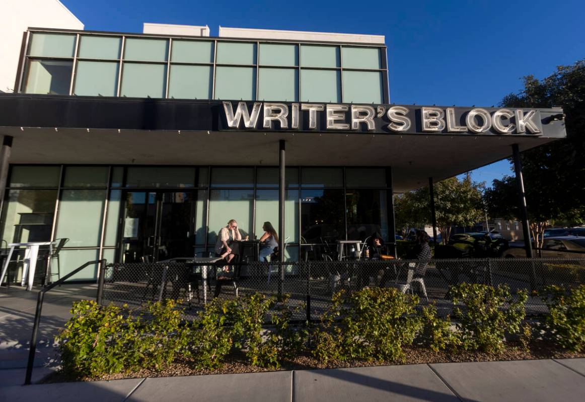 People sit outside the Writer’s Block, Wednesday, Nov. 13, 2024, in Las Vegas. (Daniel J ...