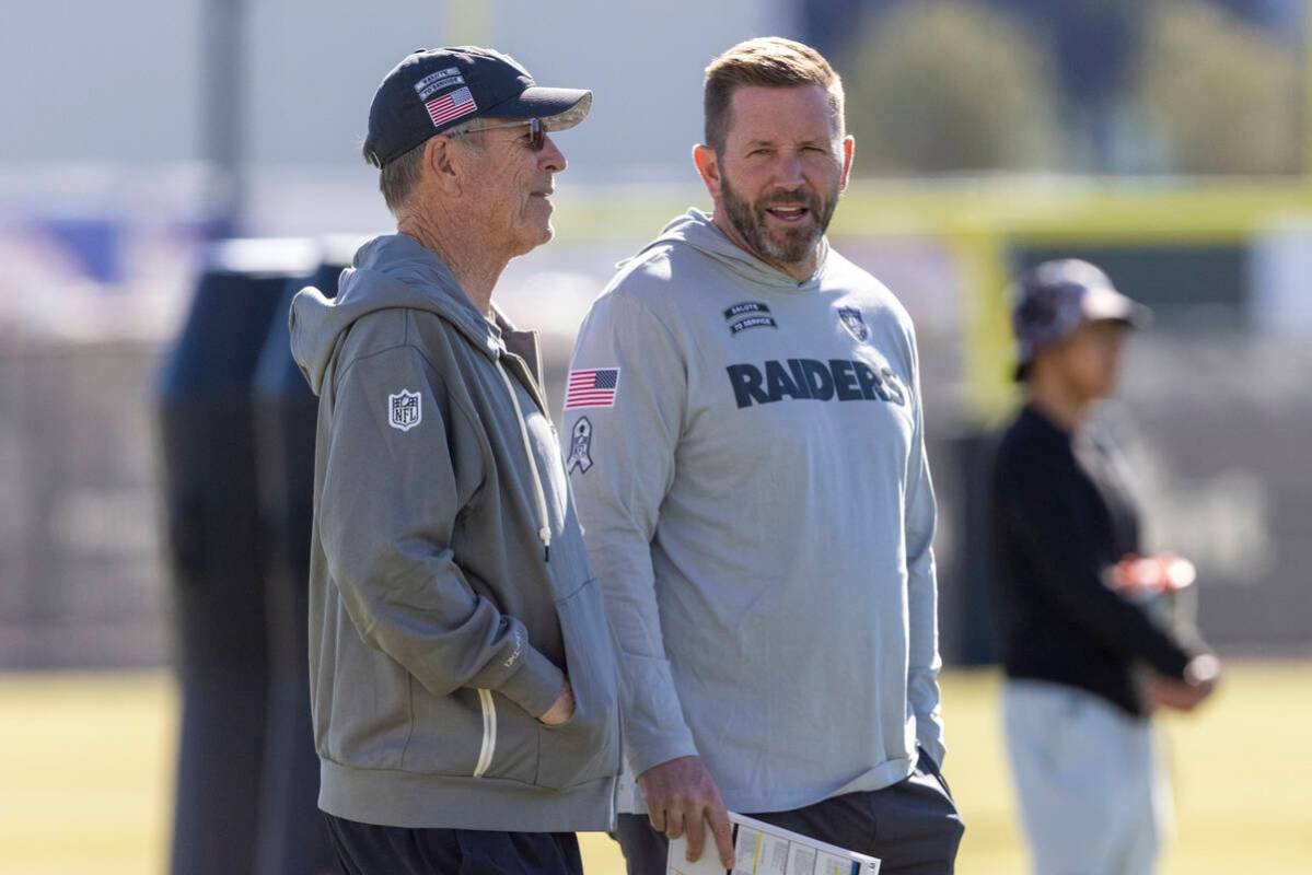 Raiders interim offensive coordinator Scott Turner, right, speaks with his father and senior of ...