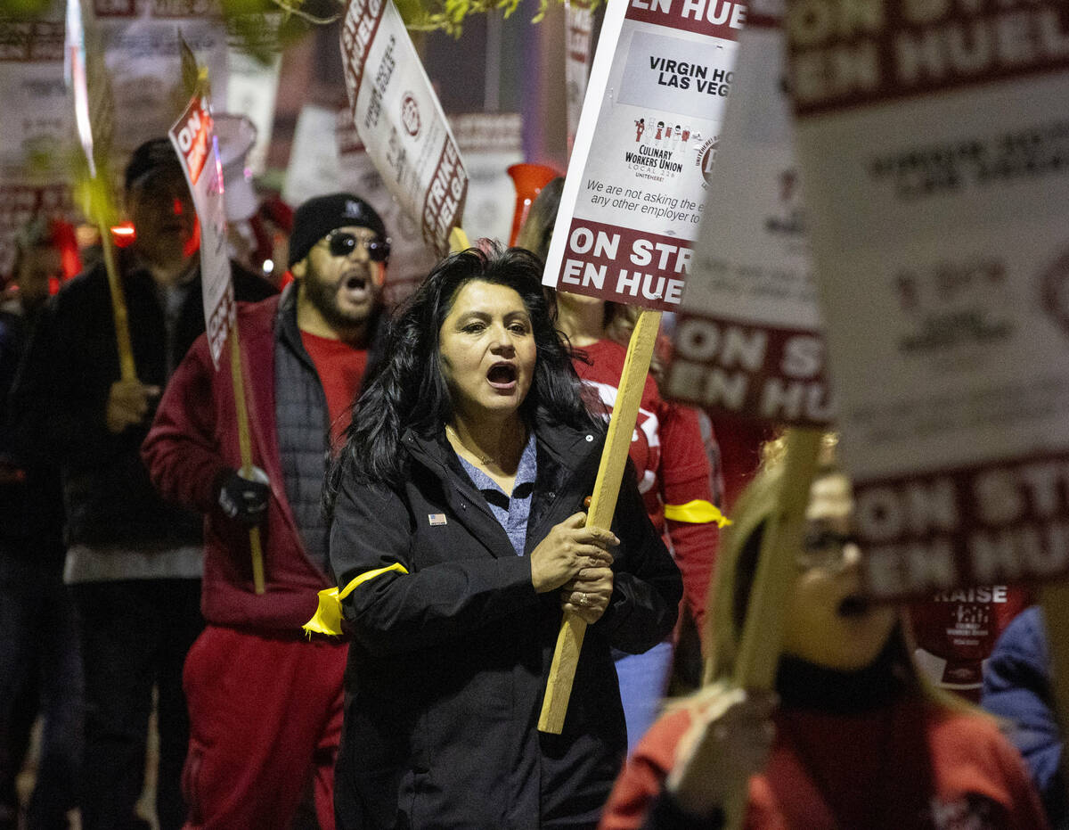 Culinary Workers Union members and Virgin Hotels workers chant and march along a picket line du ...