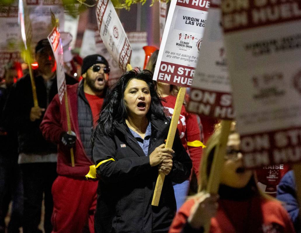 Culinary Workers Union members and Virgin Hotels workers chant and march along a picket line du ...