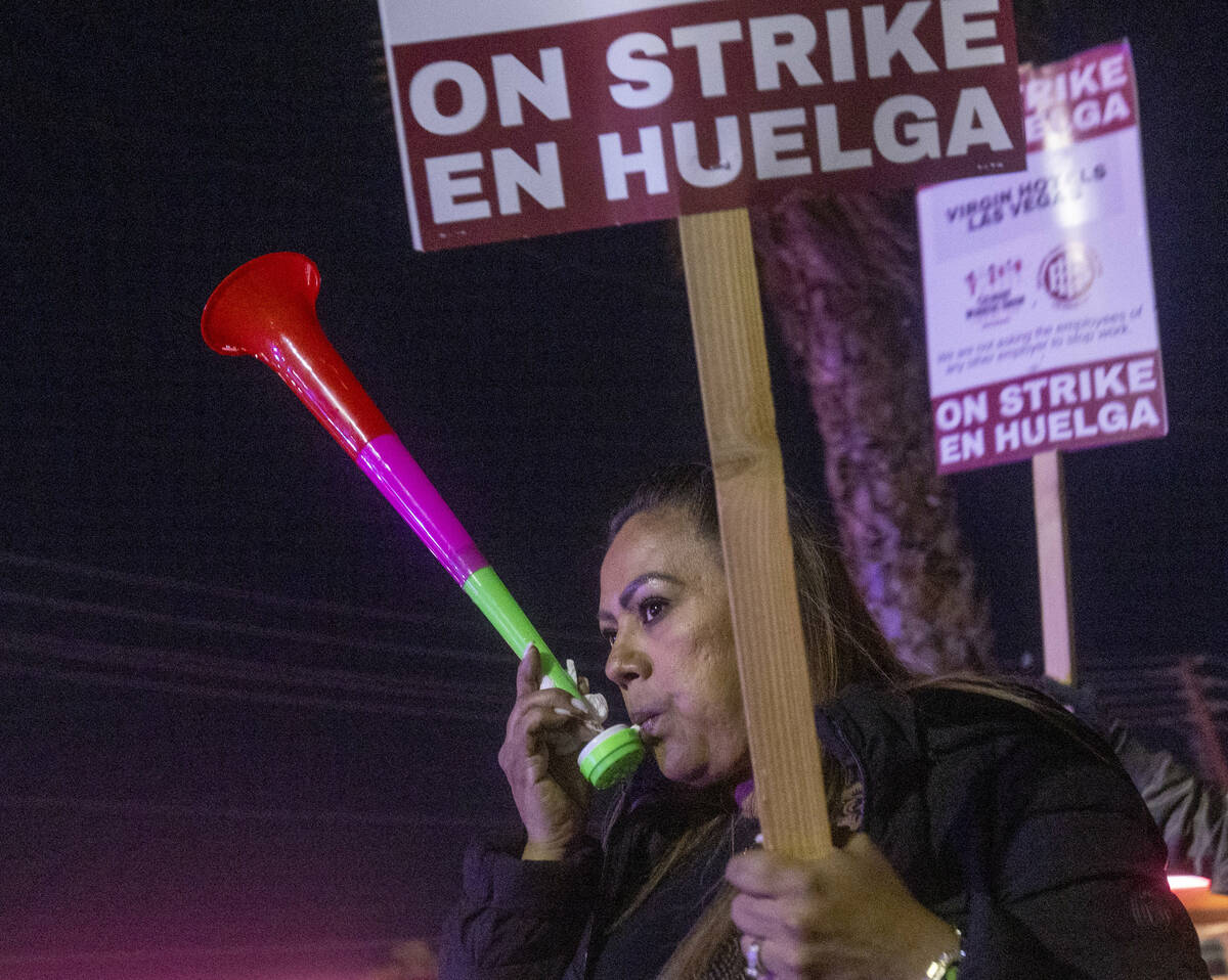 Culinary Workers Union members and Virgin Hotels workers blow horns and march along a picket li ...