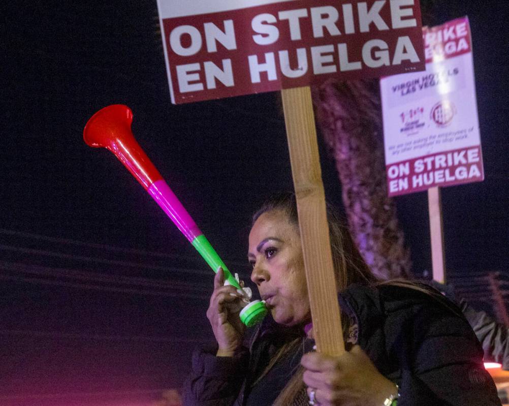 Culinary Workers Union members and Virgin Hotels workers blow horns and march along a picket li ...