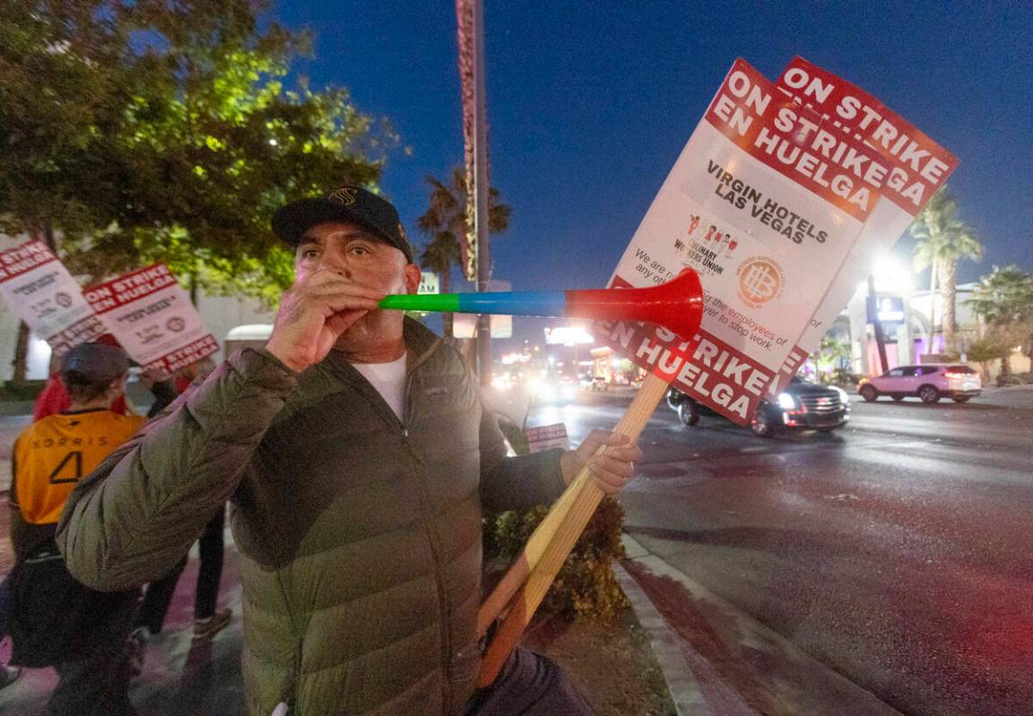 Culinary Workers Union members and Virgin Hotels workers blow horns along a picket line during ...