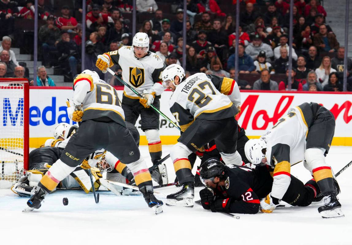 Vegas Golden Knights goaltender Ilya Samsonov, bottom left, watches the puck as Golden Knights ...