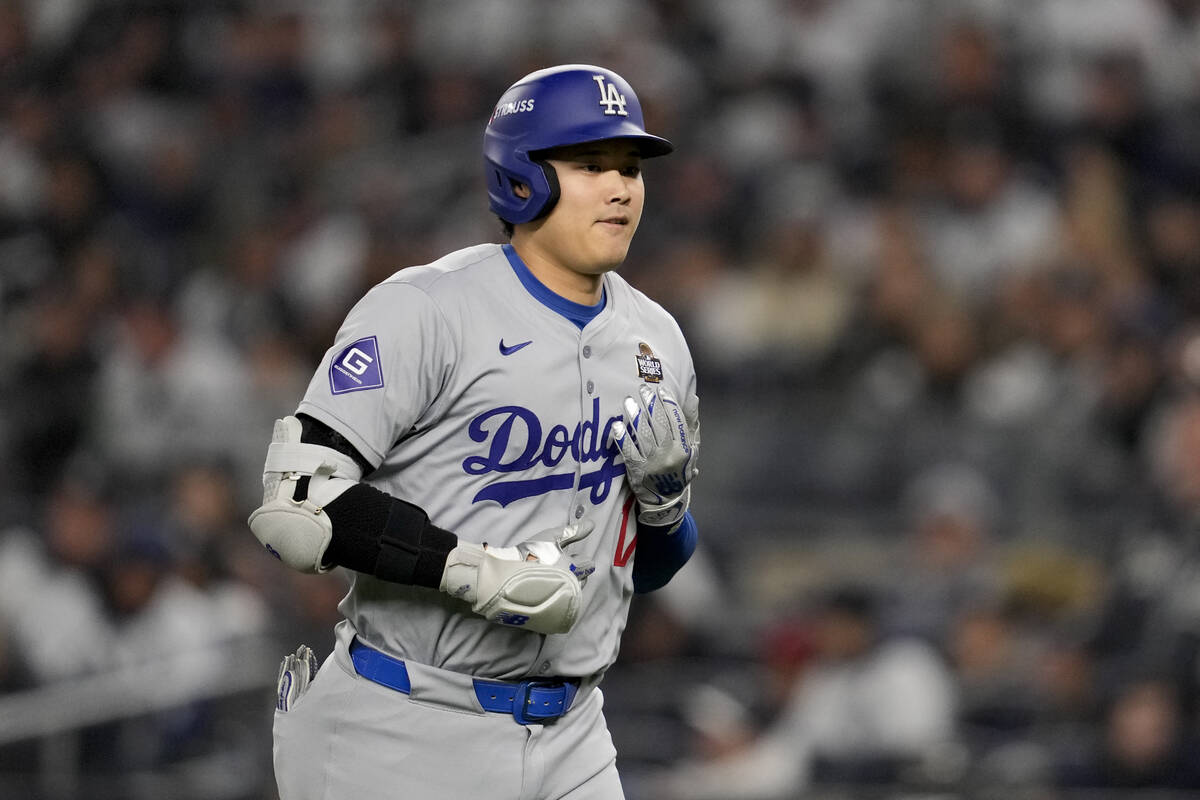 Los Angeles Dodgers' Shohei Ohtani walks to the dugout after a pop out against the New York Yan ...