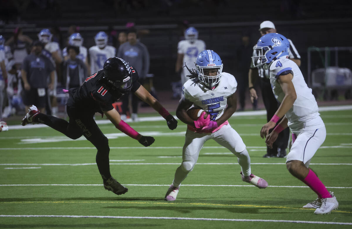 Centennial running back Khy Harris (5) runs the ball under pressure from Las Vegas defensive en ...