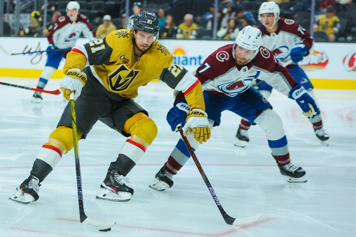 Golden Knights center Brett Howden (21) brings the puck in while Colorado Avalanche defenseman ...