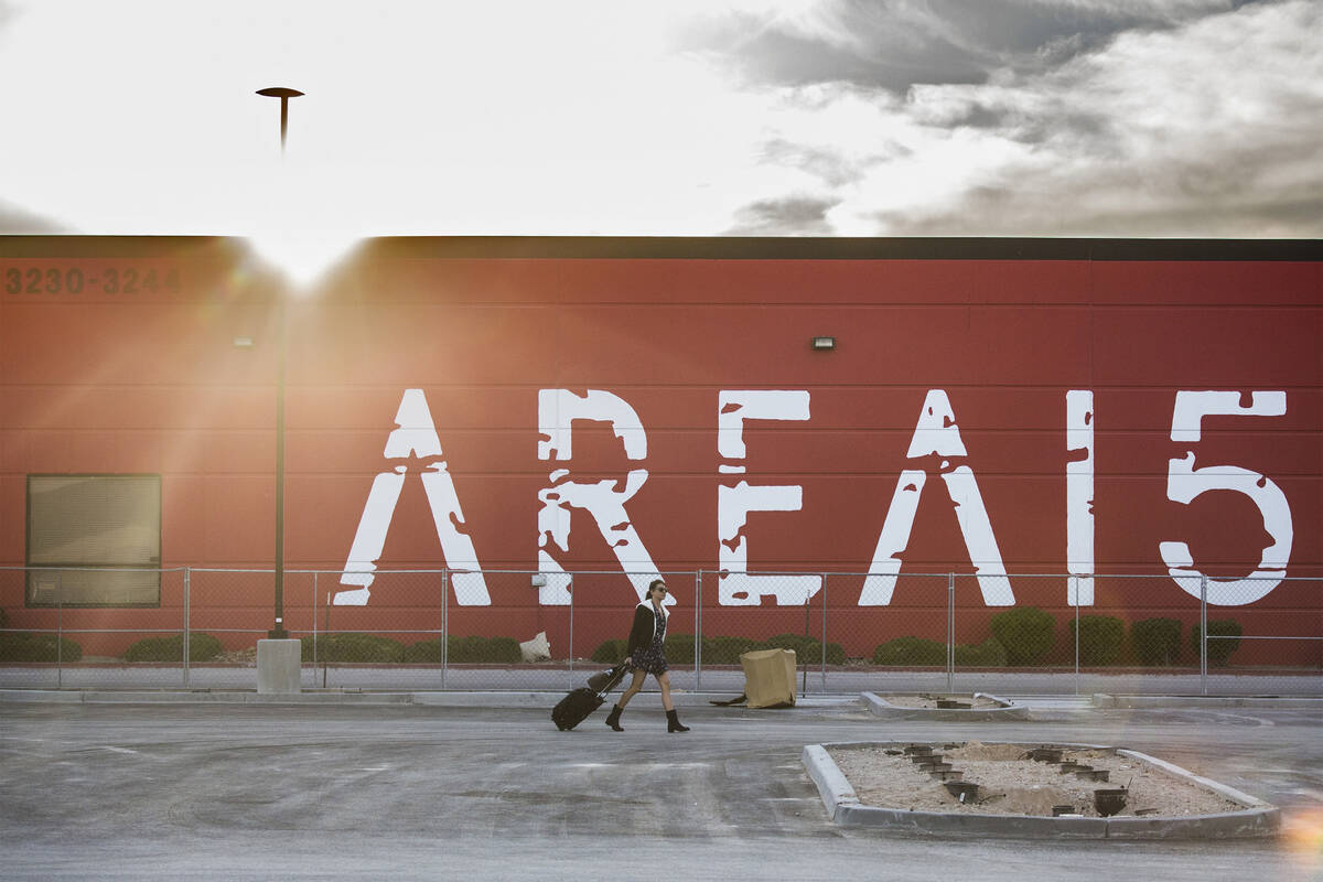 Jessica Fisher walks across the parking lot of AREA15, an experiential retail and entertainment ...