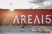 Jessica Fisher walks across the parking lot of AREA15, an experiential retail and entertainment ...