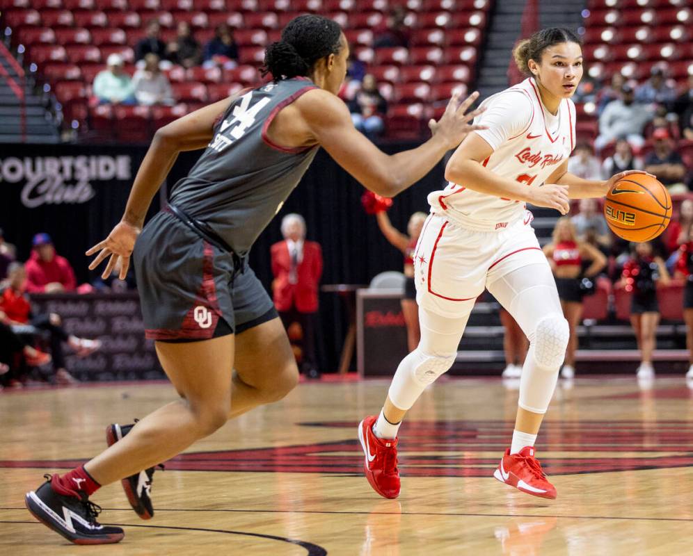 UNLV forward McKinna Brackens (21) looks to pass Oklahoma Sooners forward Liz Scott (34) during ...