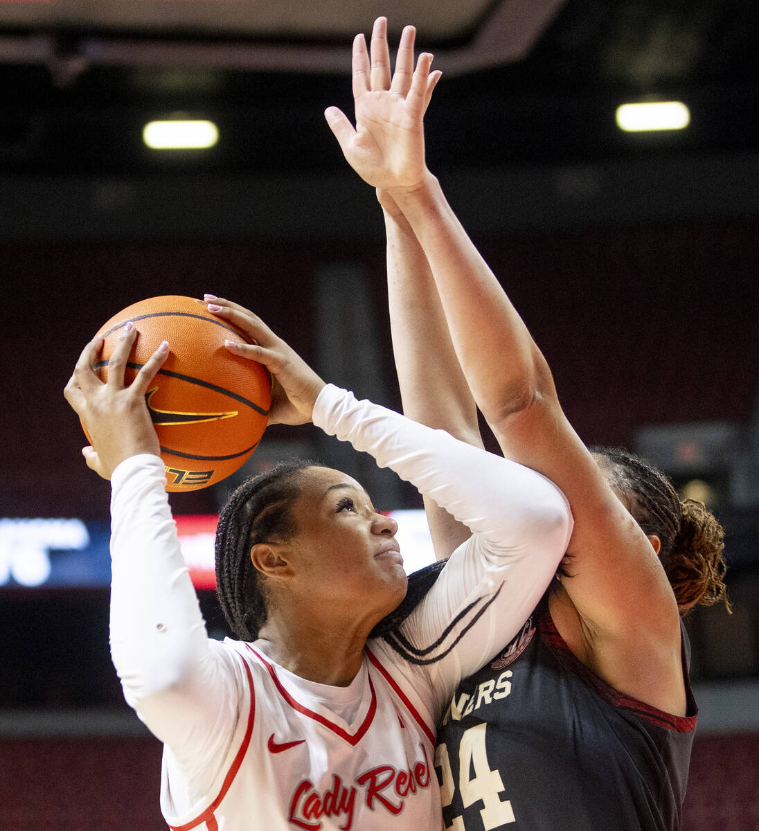 UNLV forward Alyssa Brown, left, attempts a shot around Oklahoma Sooners forward Skylar Vann, r ...