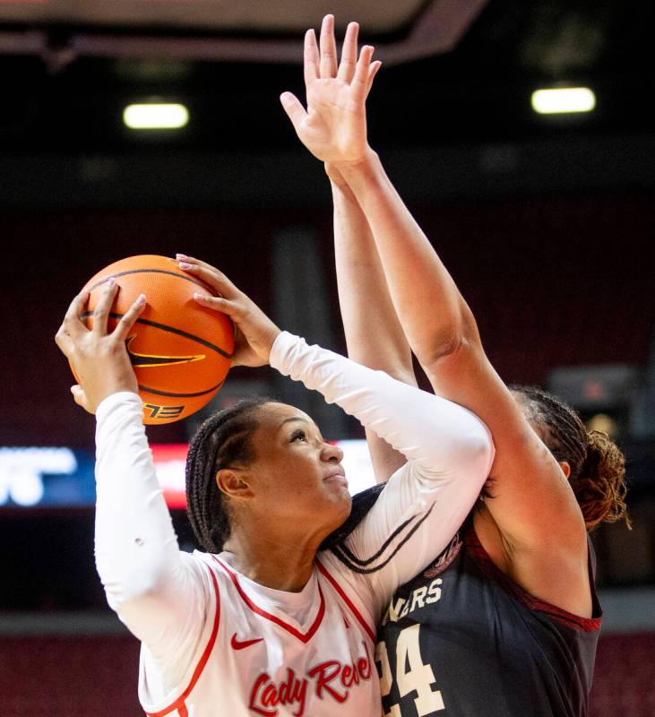 UNLV forward Alyssa Brown, left, attempts a shot around Oklahoma Sooners forward Skylar Vann, r ...