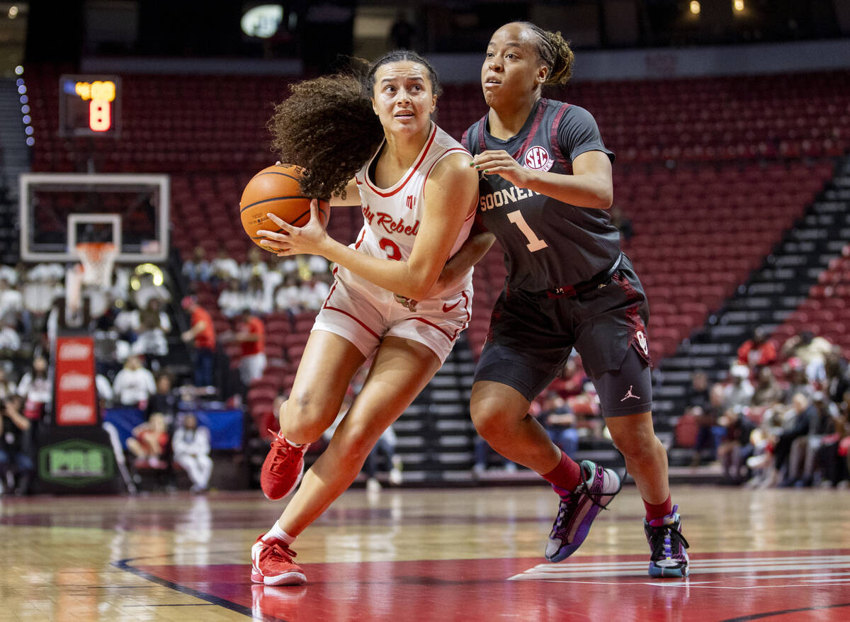 UNLV guard Kiara Jackson (3) attempts to pass Oklahoma Sooners guard Nevaeh Tot (1) during the ...