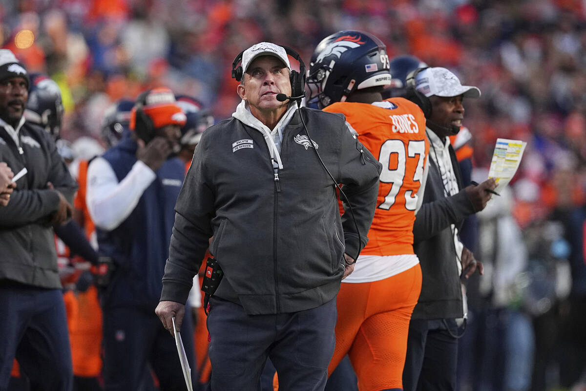 Denver Broncos head coach Sean Payton makes a call against the Atlanta Falcons during an NFL fo ...