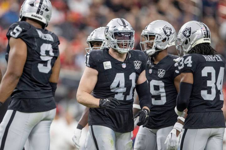 Raiders linebacker Robert Spillane (41) interacts with safety Thomas Harper (34) with cornerbac ...