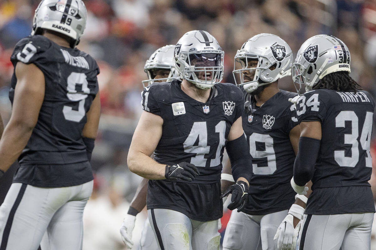 Raiders linebacker Robert Spillane (41) interacts with safety Thomas Harper (34) with cornerbac ...