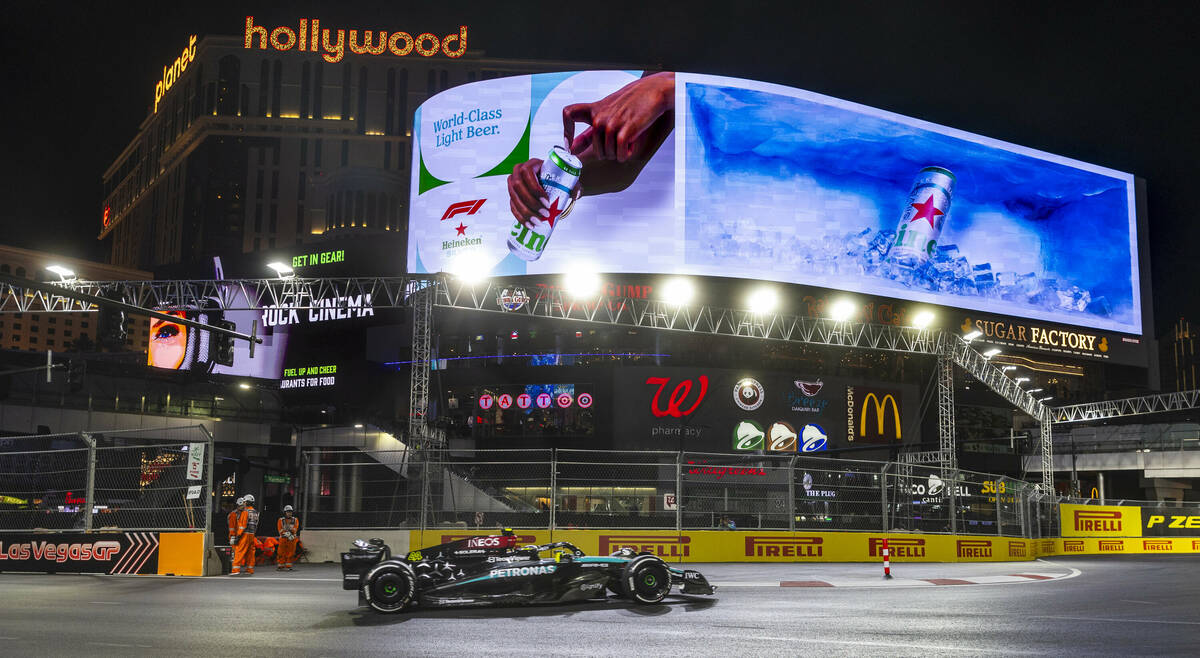 Mercedes driver Lewis Hamilton turns the corner off of the Strip during the third practice roun ...