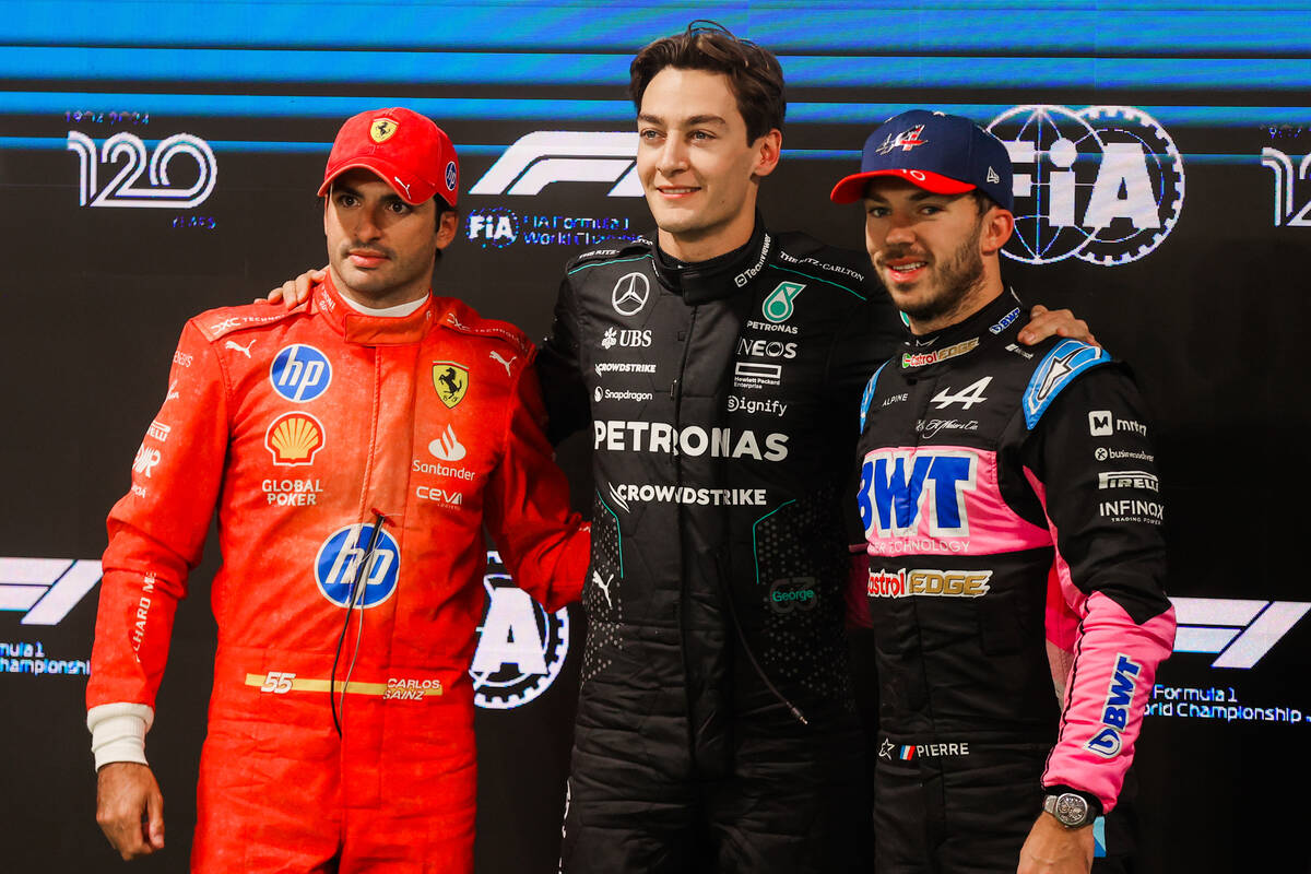 Formula 1 drivers Carlos Sainz, from left, George Russell and Pierre Gasly pose after coming in ...