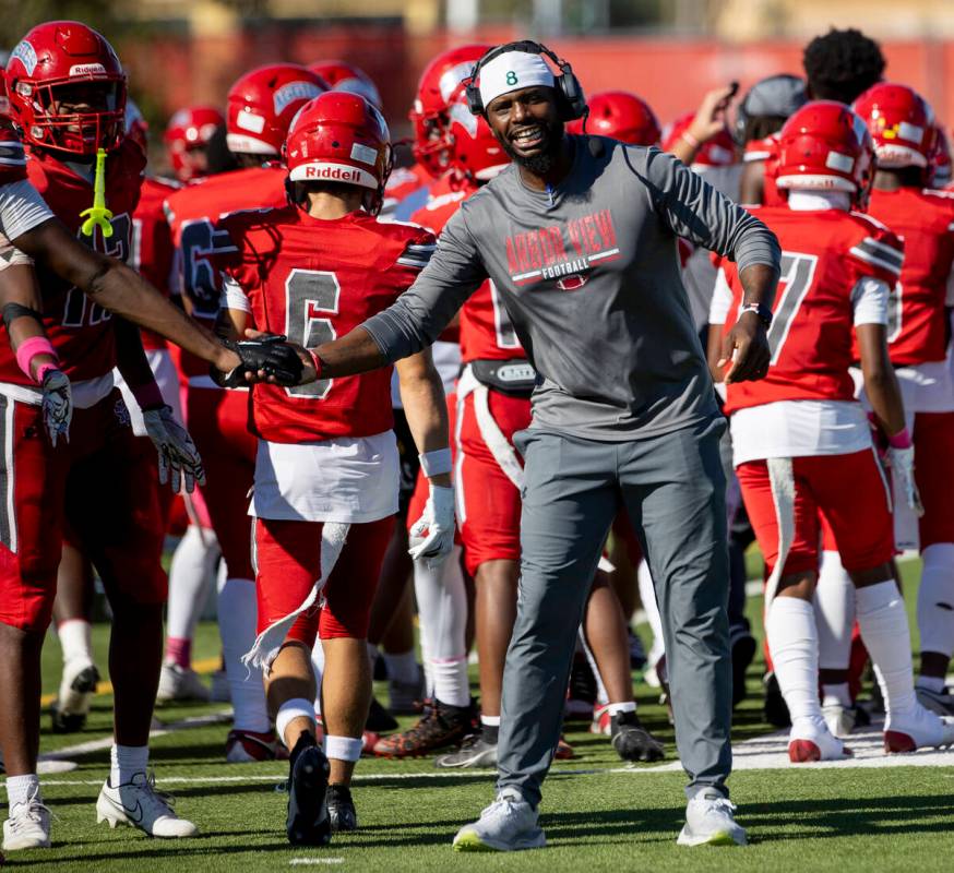 Arbor View Head Coach Marlon Barnett welcomes the offense back to the sideline after scoring a ...