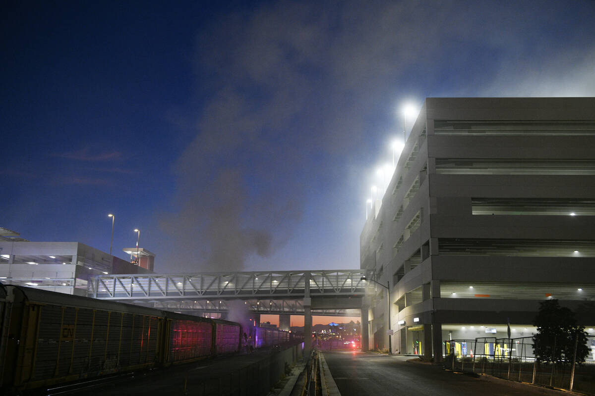 Firefighters work to put out a fire in a railcar carrying autos Friday, November 22, 2024, near ...