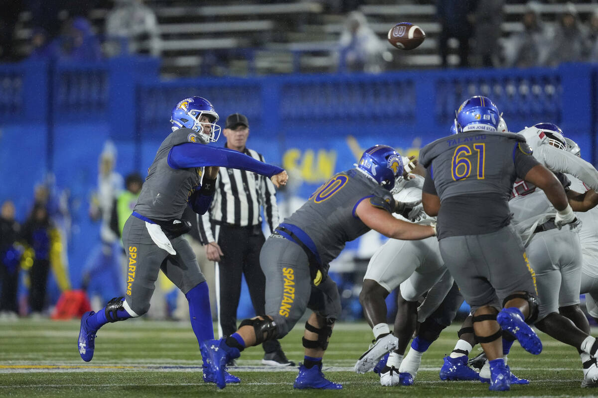 San Jose State quarterback Walker Eget, left, passes during the first half of an NCAA college f ...