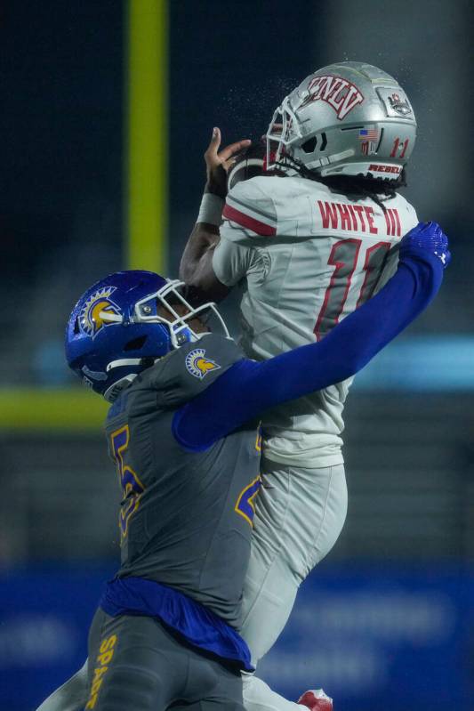 UNLV wide receiver Ricky White III, right, catches a pass while defended by San Jose State defe ...