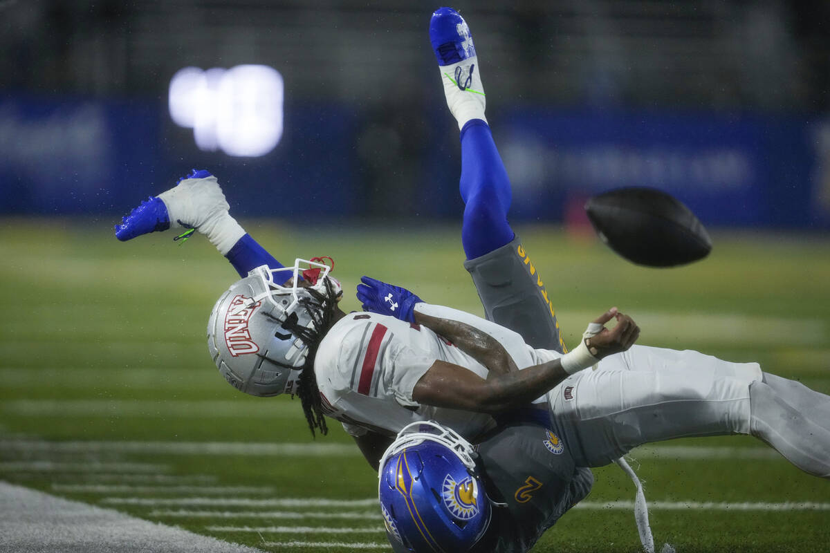 San Jose State defensive back DJ Harvey, bottom, breaks up a pass intended for UNLV wide receiv ...