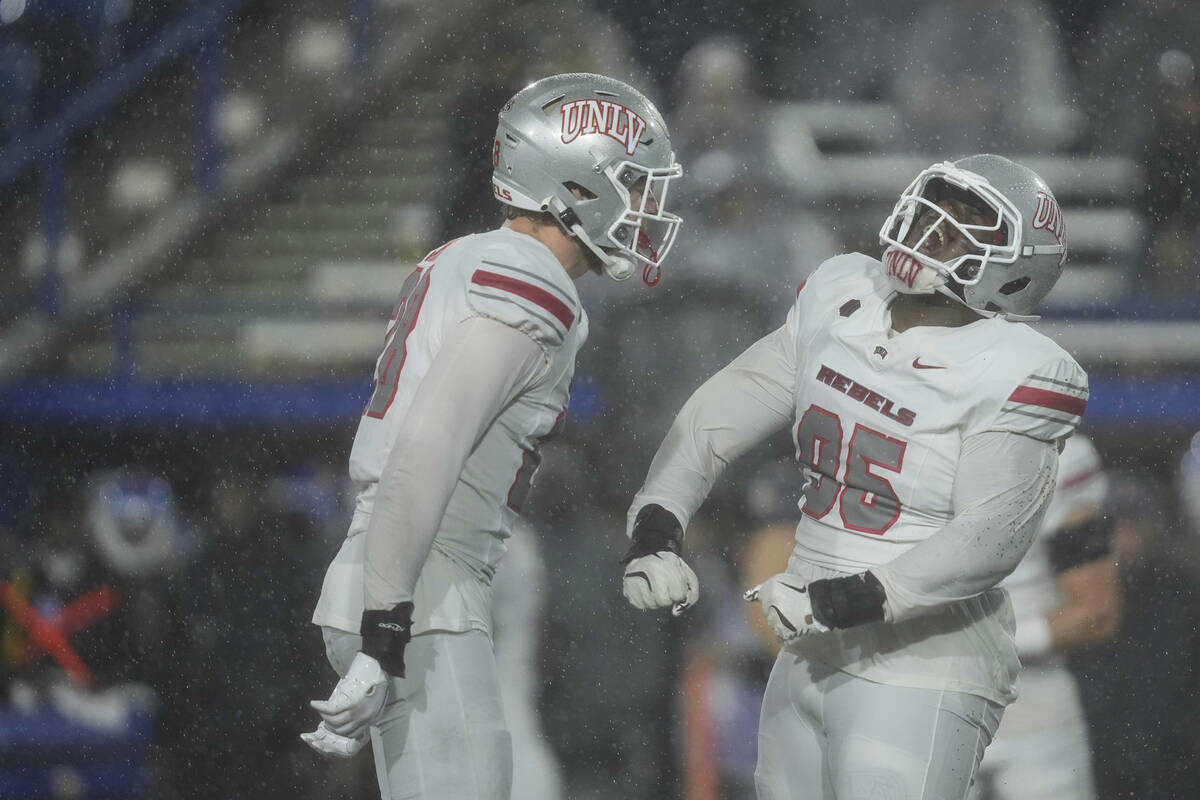 UNLV defensive lineman Alexander Whitmore, right, reacts after making a tackle against San Jose ...