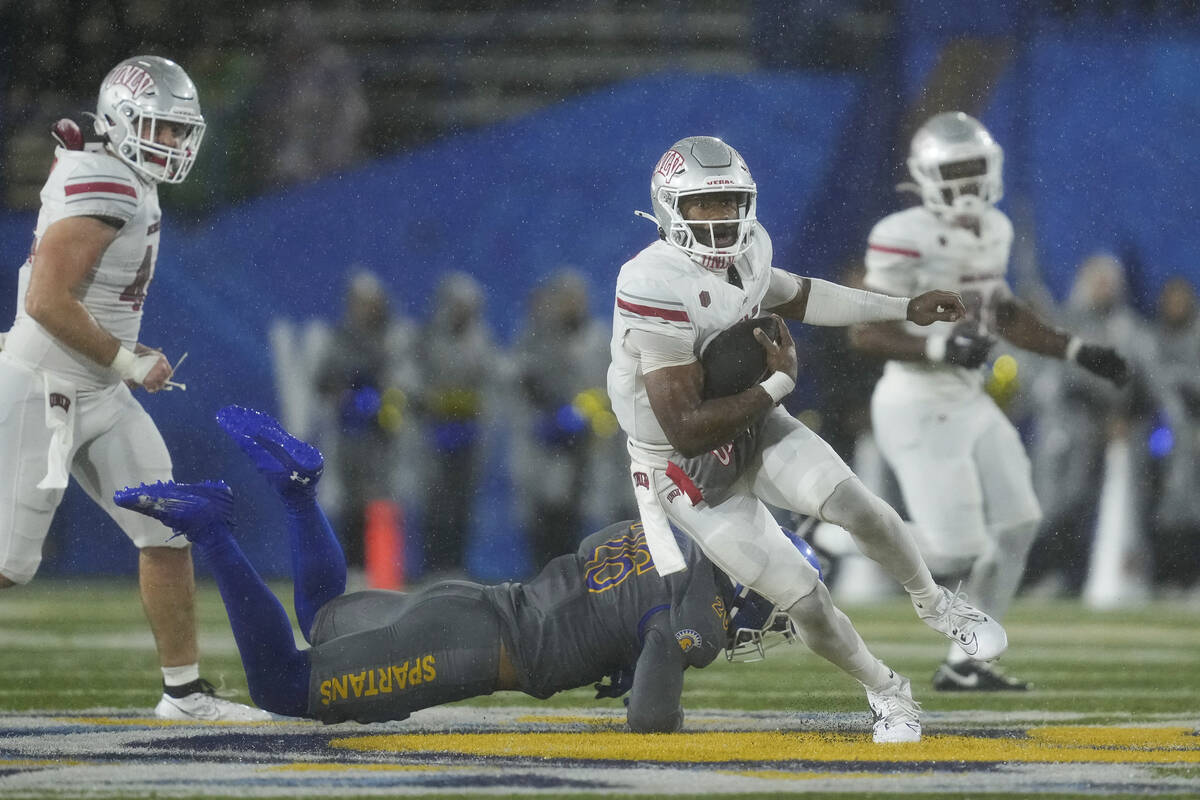 UNLV quarterback Hajj-Malik Williams, right, runs past San Jose State linebacker Ethan Powell ( ...