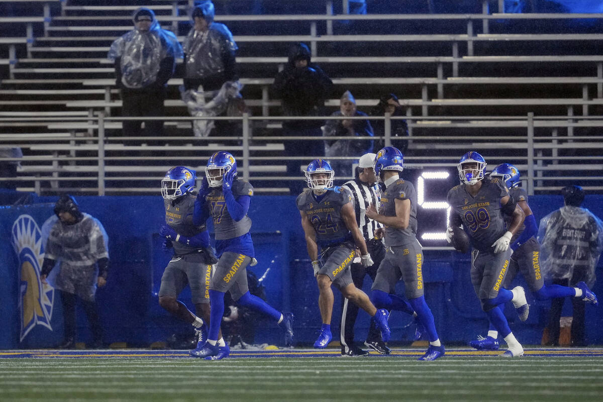 San Jose State defenders celebrate after scoring a safety during the first half of an NCAA coll ...