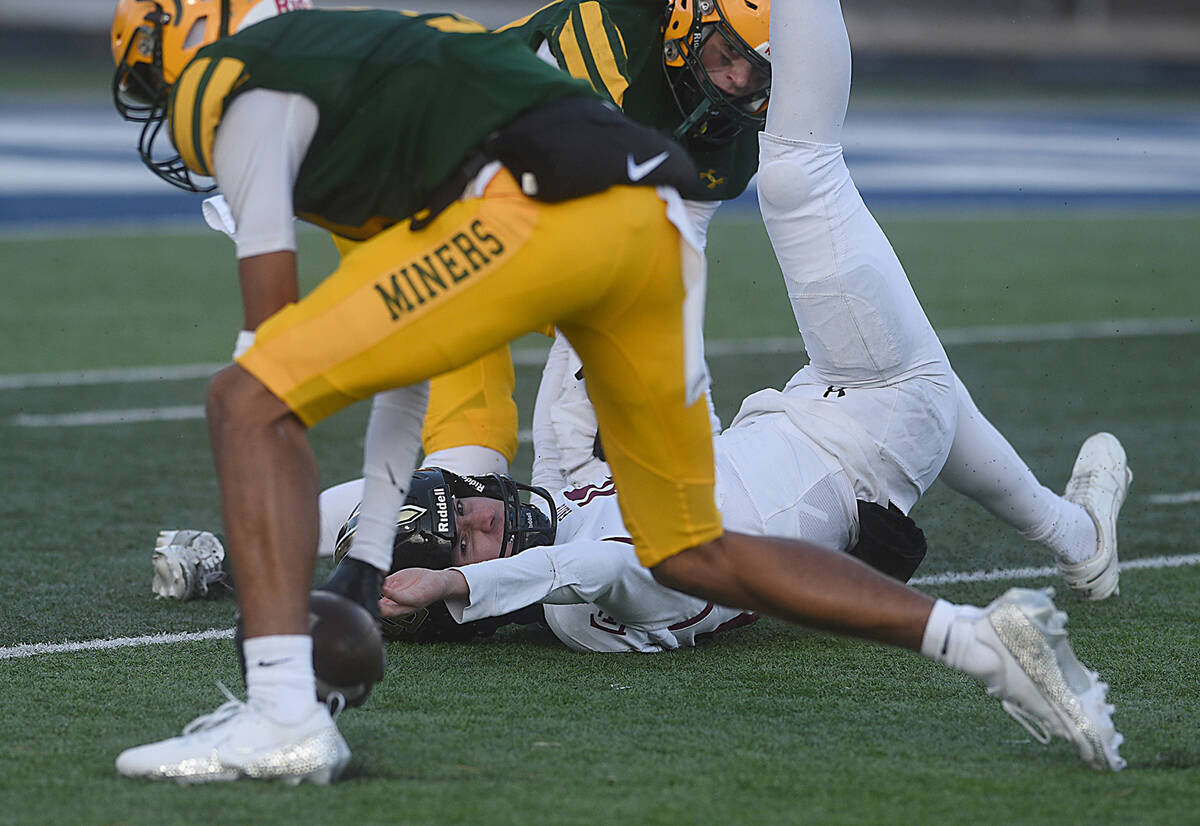 Faith Lutheran quarterback Alex Rogers loses the ball after getting sacked by Bishop Manogue in ...