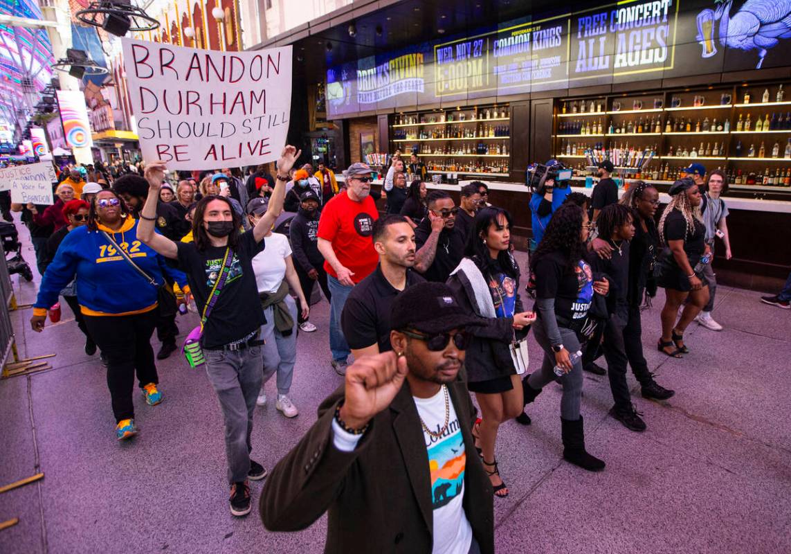 People march along the Fremont Street Experience during a rally for Brandon Durham, who was sho ...