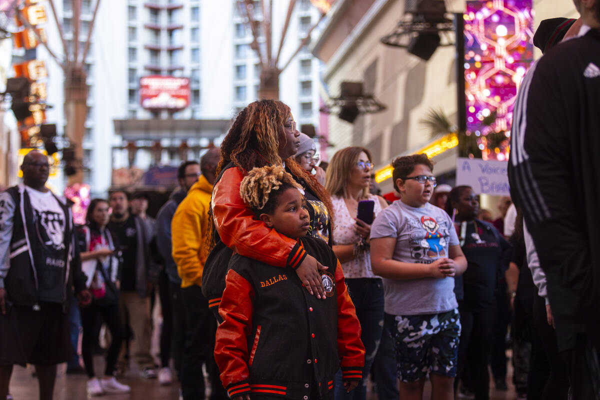 People march along the Fremont Street Experience during a rally for Brandon Durham, who was sho ...