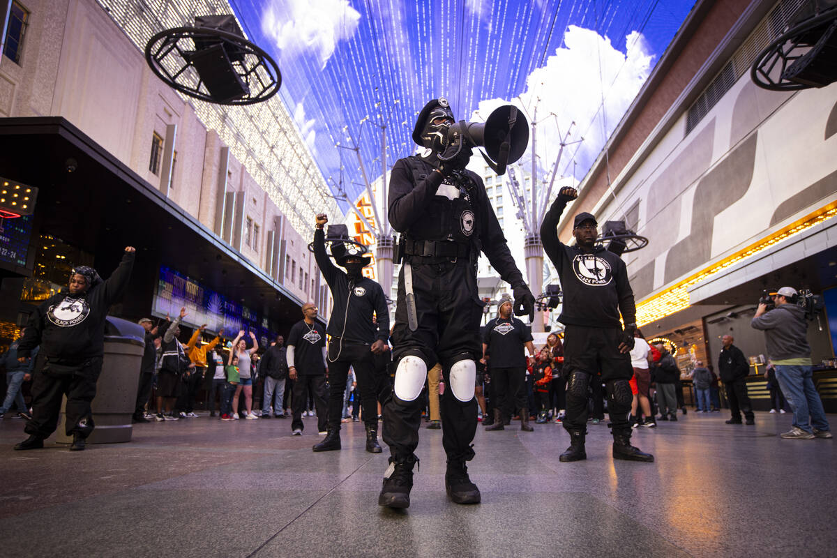 People march along the Fremont Street Experience during a rally for Brandon Durham, who was sho ...