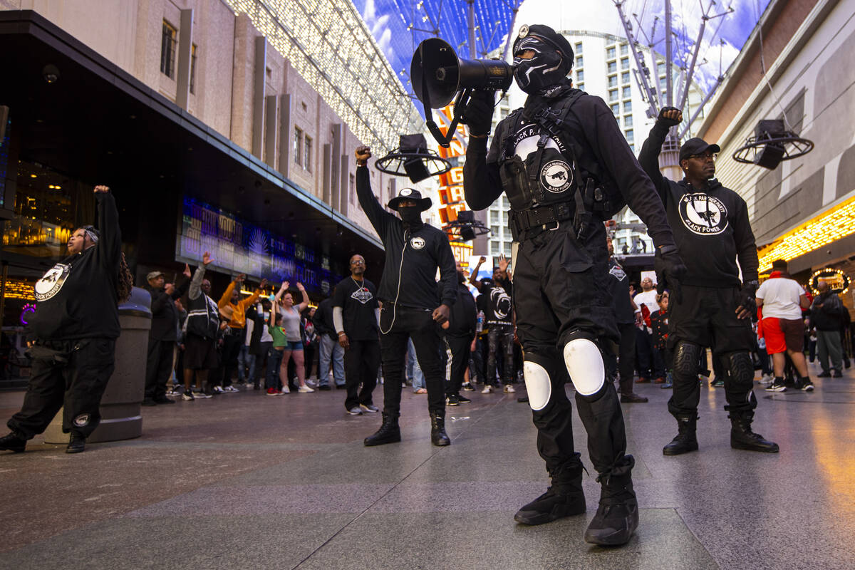 People march along the Fremont Street Experience during a rally for Brandon Durham, who was sho ...